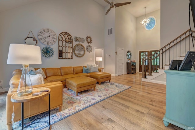5007 W Michael Ln, Bloomington, IN 47404 - living area featuring wood finished floors, high vaulted ceiling, stairs, and ceiling fan