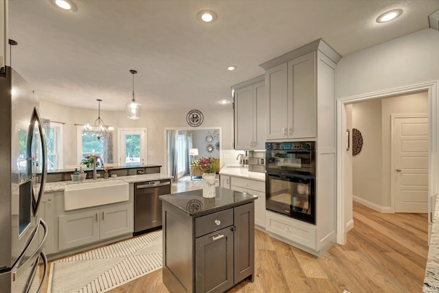 5007 W Michael Ln, Bloomington, IN 47404 - kitchen featuring appliances with stainless steel finishes, gray cabinetry, dark stone countertops, and recessed lighting
