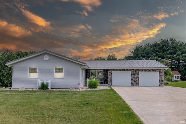 906 N Townline Rd, Lagrange, IN 46761 - view of front of property with an attached garage, driveway, a front yard, and a metal roof