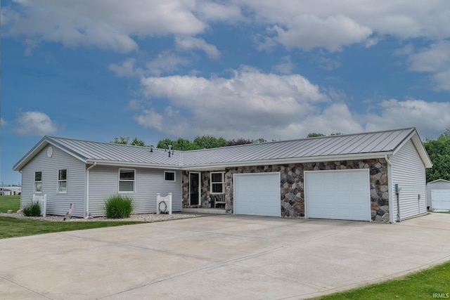 906 N Townline Rd, Lagrange, IN 46761 - ranch-style home featuring driveway, a standing seam roof, an attached garage, a metal roof, and stone siding