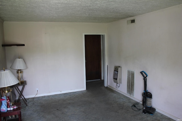 2012 S Vine St, Muncie, IN 47302 - unfurnished living room featuring heating unit, a textured ceiling, and carpet flooring