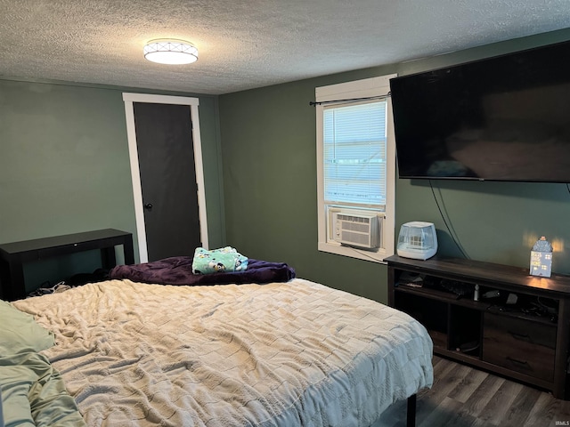 562 Railroad St, Wabash, IN 46992 - bedroom featuring dark wood-type flooring, a textured ceiling, cooling unit, and a closet