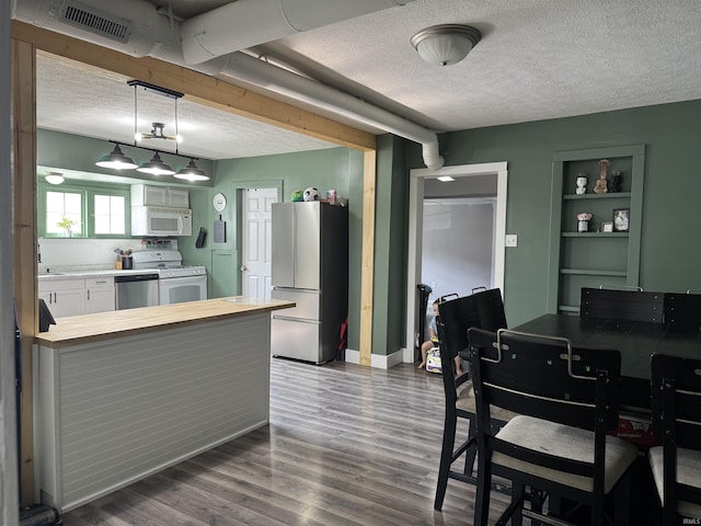 562 Railroad St, Wabash, IN 46992 - kitchen with white appliances, a textured ceiling, butcher block countertops, a peninsula, and dark wood-style floors