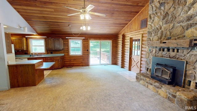 4115 N Aquarius Dr, Monticello, IN 47960 - kitchen with wood ceiling, lofted ceiling, light colored carpet, log walls, and brown cabinets