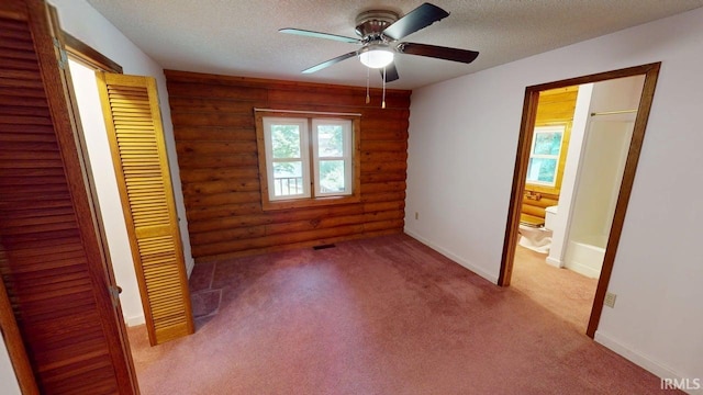 4115 N Aquarius Dr, Monticello, IN 47960 - unfurnished bedroom featuring rustic walls, a textured ceiling, carpet, ensuite bath, and a closet