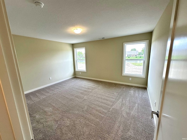 1466 Monte Carlo Dr, Huntertown, IN 46748 - empty room with carpet flooring, a smoke detector, and a textured ceiling