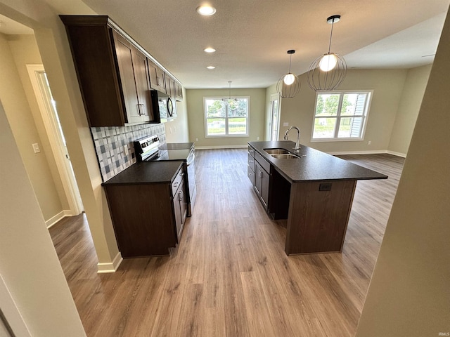 1466 Monte Carlo Dr, Huntertown, IN 46748 - kitchen with range with electric stovetop, dark countertops, stainless steel microwave, wood finished floors, and recessed lighting