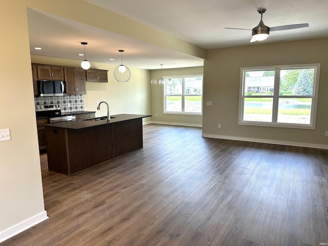 1466 Monte Carlo Dr, Huntertown, IN 46748 - kitchen with stainless steel electric range, dark countertops, dark wood-style flooring, and open floor plan