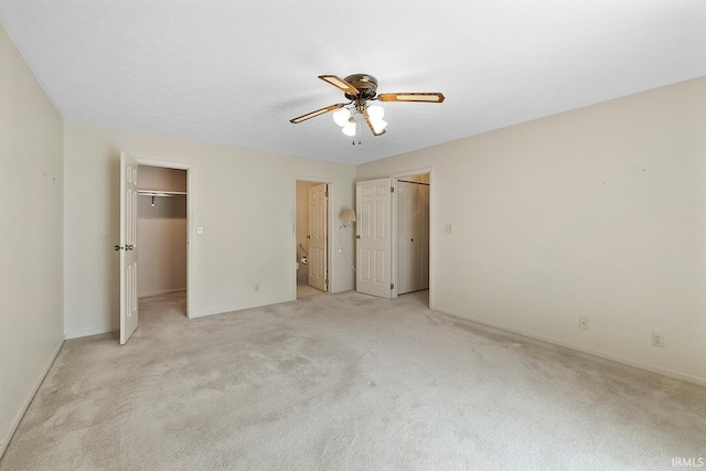 106 W Navajo St, West Lafayette, IN 47906 - unfurnished bedroom with light colored carpet, a walk in closet, ensuite bath, and a ceiling fan