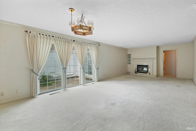106 W Navajo St, West Lafayette, IN 47906 - unfurnished living room with a chandelier, a textured ceiling, carpet floors, and a glass covered fireplace
