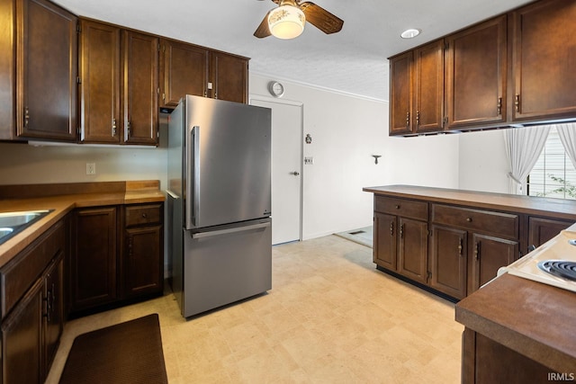 106 W Navajo St, West Lafayette, IN 47906 - kitchen with freestanding refrigerator, a ceiling fan, light flooring, ornamental molding, and dark brown cabinetry