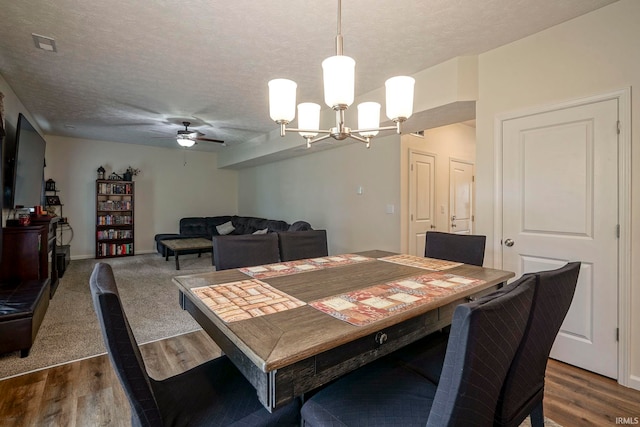 140 Wadsworth Ct, Lafayette, IN 47905 - dining room featuring a chandelier, dark wood-type flooring, a ceiling fan, and a textured ceiling