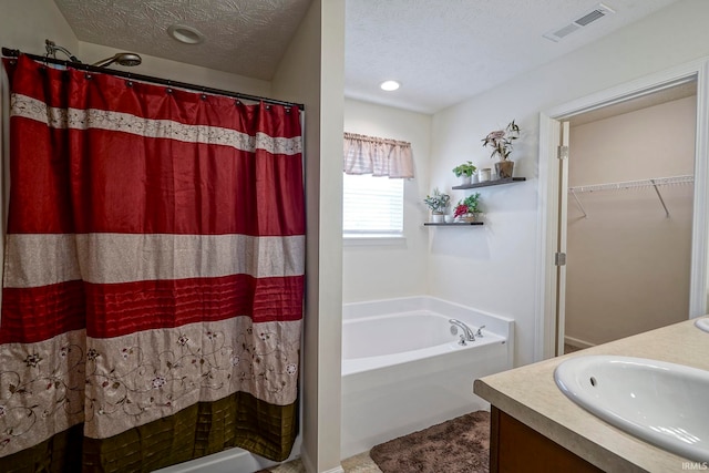 140 Wadsworth Ct, Lafayette, IN 47905 - bathroom with a bath, vanity, a textured ceiling, curtained shower, and a spacious closet