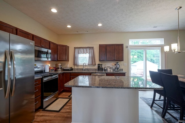 140 Wadsworth Ct, Lafayette, IN 47905 - kitchen with appliances with stainless steel finishes, a textured ceiling, dark wood-style floors, a chandelier, and a center island