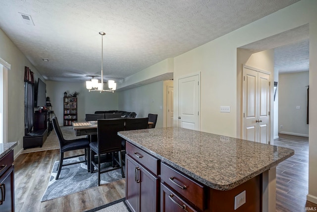 140 Wadsworth Ct, Lafayette, IN 47905 - kitchen with dark wood-type flooring, open floor plan, a chandelier, a textured ceiling, and a kitchen island