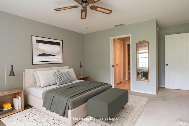 3718 Grasstree Ct, Bloomington, IN 47401 - carpeted bedroom with baseboards and a ceiling fan