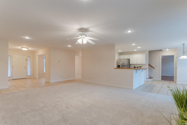 7561 Saint Jordan Cir, Newburgh, IN 47630 - unfurnished living room with light tile patterned floors, light carpet, recessed lighting, stairs, and ceiling fan