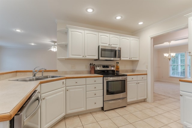 7561 Saint Jordan Cir, Newburgh, IN 47630 - kitchen with stainless steel appliances, a chandelier, light tile patterned floors, ornamental molding, and white cabinets