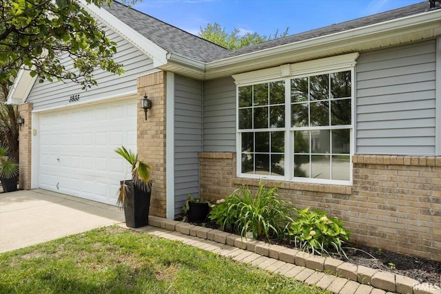 3933 Electra Ct, Lafayette, IN 47905 - view of side of property featuring brick siding, driveway, an attached garage, and roof with shingles