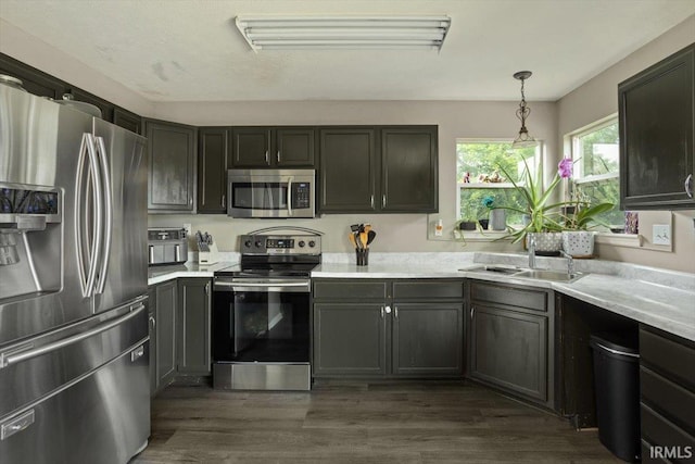 3933 Electra Ct, Lafayette, IN 47905 - kitchen featuring stainless steel appliances, light countertops, decorative light fixtures, and dark wood-type flooring