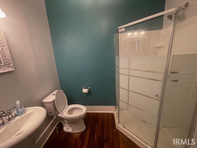 608 W Main St, Greentown, IN 46936 - bathroom with a shower stall and wood finished floors