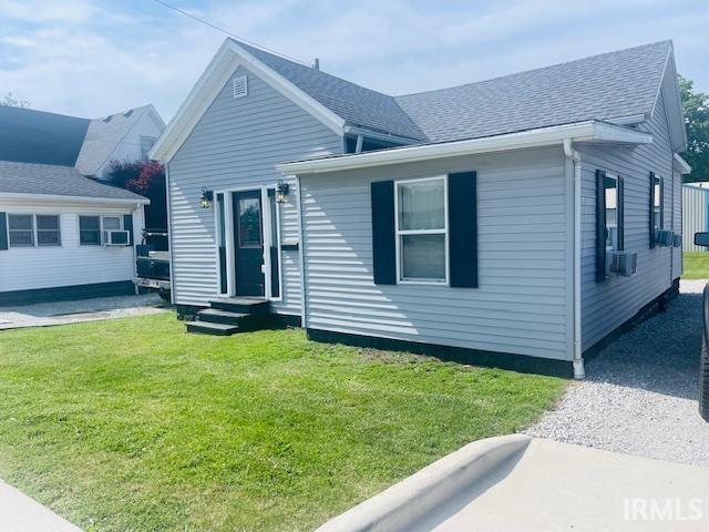 608 W Main St, Greentown, IN 46936 - view of front facade featuring a shingled roof and a front lawn