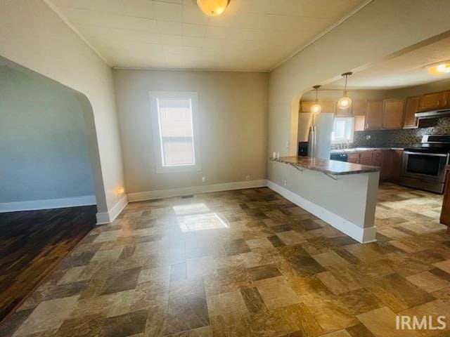 608 W Main St, Greentown, IN 46936 - kitchen with stainless steel appliances, arched walkways, ventilation hood, plenty of natural light, and ornamental molding