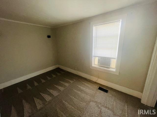 608 W Main St, Greentown, IN 46936 - empty room featuring dark carpet and ornamental molding