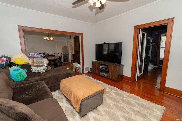 1121 S 23rd St, South Bend, IN 46615 - living area featuring wood finished floors, a ceiling fan, a chandelier, and crown molding