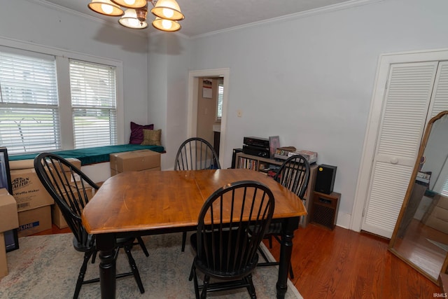 1121 S 23rd St, South Bend, IN 46615 - dining space with healthy amount of natural light, a chandelier, ornamental molding, and wood finished floors