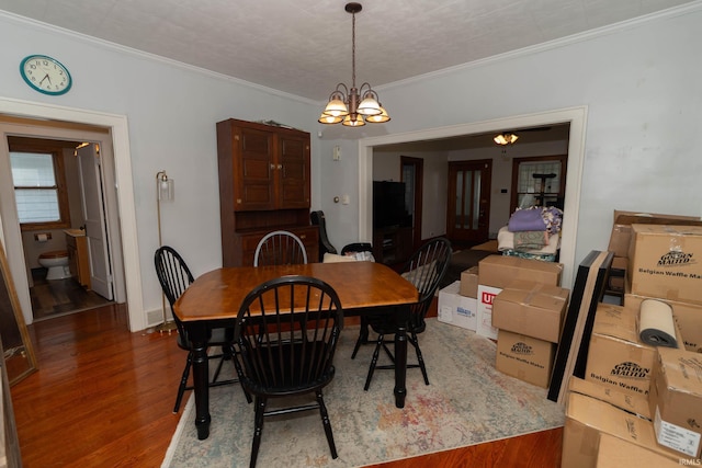 1121 S 23rd St, South Bend, IN 46615 - dining area featuring a chandelier, wood finished floors, and crown molding