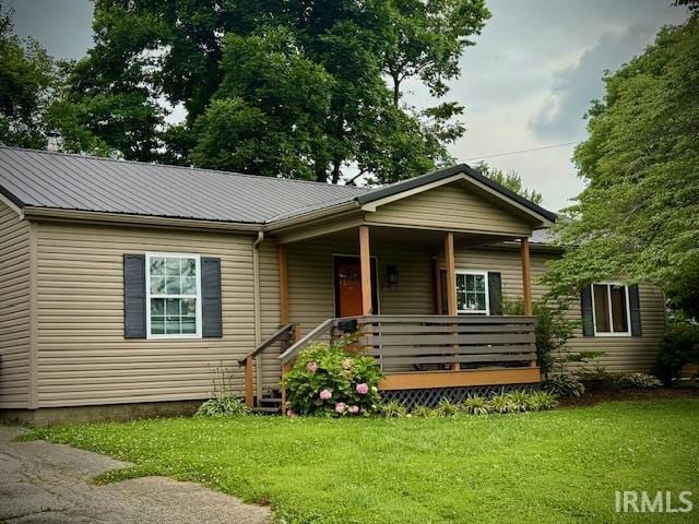 701 E Water St, Princeton, IN 47670 - bungalow featuring a front yard, a metal roof, and a porch