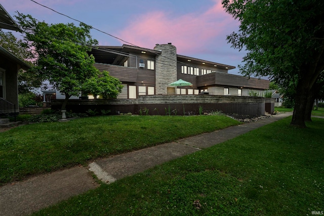 1208 Delta Blvd, Fort Wayne, IN 46805 - back of property at dusk featuring a chimney