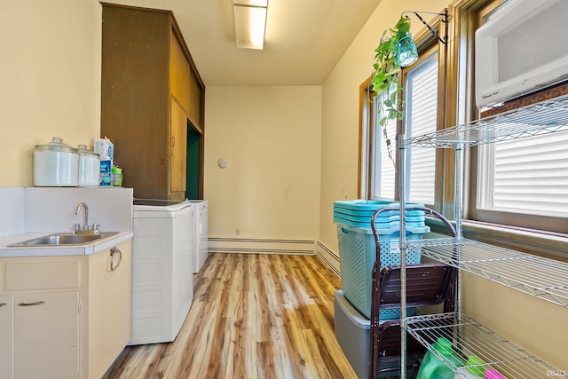 1208 Delta Blvd, Fort Wayne, IN 46805 - laundry room featuring baseboard heating, light wood-style floors, healthy amount of natural light, and independent washer and dryer