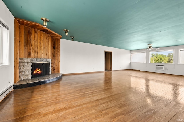 1208 Delta Blvd, Fort Wayne, IN 46805 - unfurnished living room with a fireplace, wood finished floors, a baseboard heating unit, a ceiling fan, and an AC wall unit
