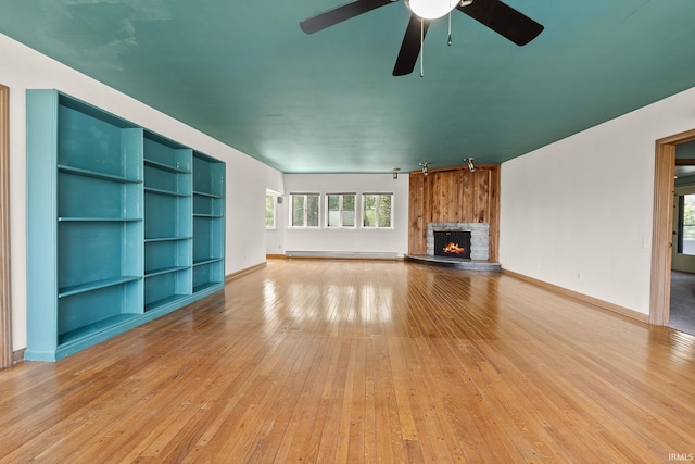 1208 Delta Blvd, Fort Wayne, IN 46805 - unfurnished living room featuring baseboard heating, a fireplace, light wood-type flooring, and ceiling fan