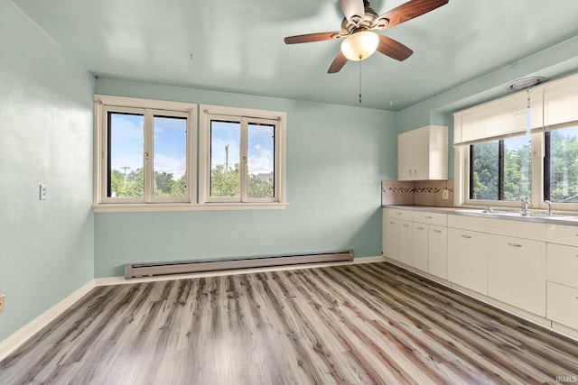 1208 Delta Blvd, Fort Wayne, IN 46805 - kitchen featuring baseboard heating, healthy amount of natural light, white cabinets, and light wood finished floors