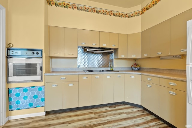 1208 Delta Blvd, Fort Wayne, IN 46805 - kitchen featuring stainless steel oven, under cabinet range hood, light wood finished floors, light countertops, and cooktop
