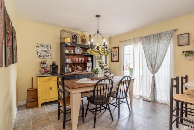 4600 N Shadow Wood Dr, Bloomington, IN 47404 - tiled dining room with a chandelier and baseboards