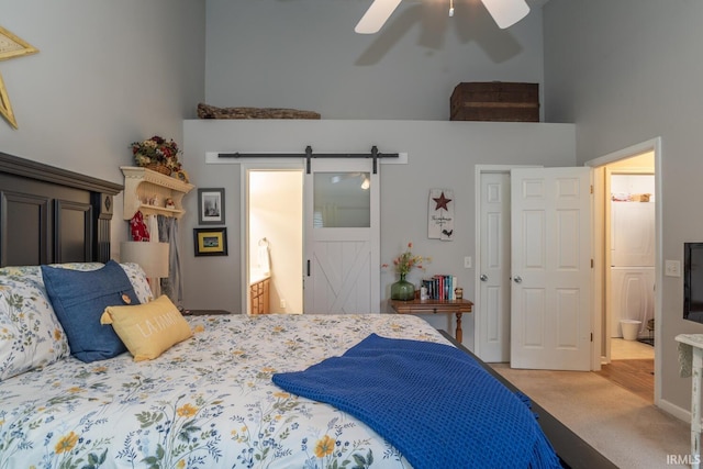 4600 N Shadow Wood Dr, Bloomington, IN 47404 - bedroom with a high ceiling, carpet floors, a barn door, ensuite bath, and ceiling fan