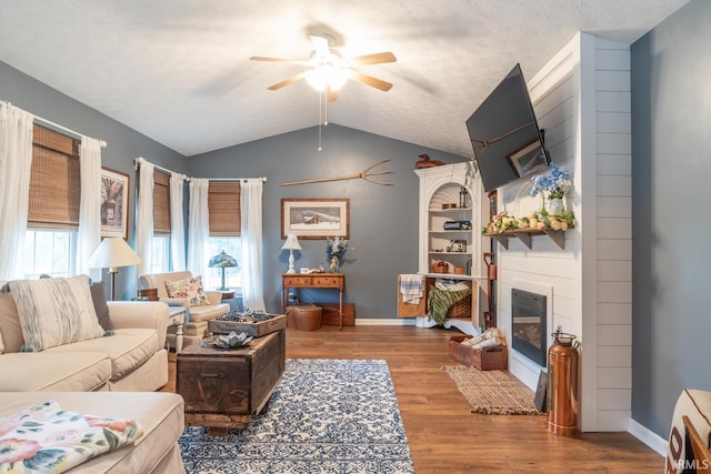 4600 N Shadow Wood Dr, Bloomington, IN 47404 - living room featuring ceiling fan, lofted ceiling, wood finished floors, and a large fireplace