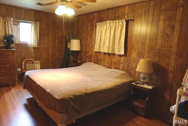 1120 E Fourth St, Mount Vernon, IN 47620 - bedroom with wood walls, wood finished floors, and ceiling fan
