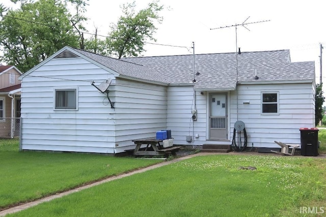 1120 E Fourth St, Mount Vernon, IN 47620 - rear view of house featuring a shingled roof, a yard, and entry steps