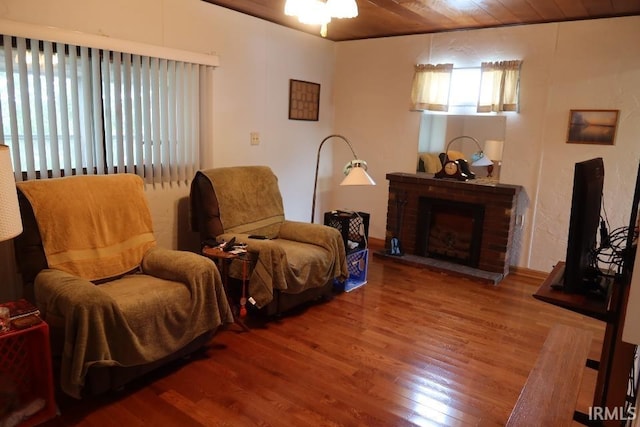 1120 E Fourth St, Mount Vernon, IN 47620 - living area featuring wood finished floors, wood ceiling, a brick fireplace, and a ceiling fan