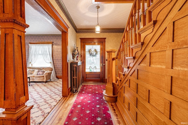 8 Hale St, Lafontaine, IN 46940 - entrance foyer with plenty of natural light, ornamental molding, a textured ceiling, stairs, and wallpapered walls