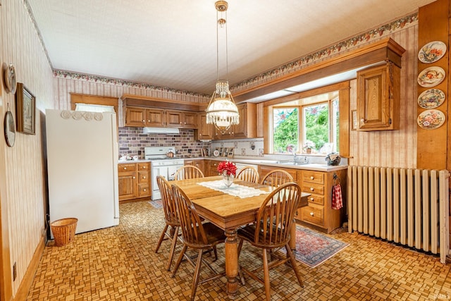 8 Hale St, Lafontaine, IN 46940 - dining room featuring radiator heating unit, wallpapered walls, a chandelier, and light flooring