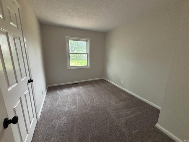 205 Corwin Ln, Fort Wayne, IN 46816 - unfurnished room with dark colored carpet and a textured ceiling