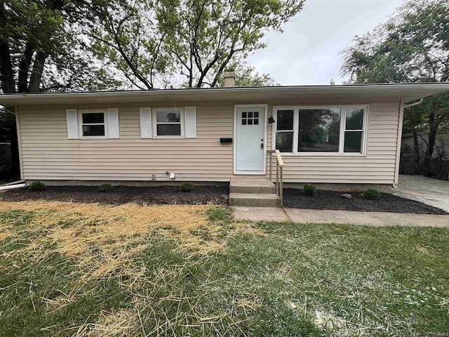 205 Corwin Ln, Fort Wayne, IN 46816 - view of front of house with a front yard, a chimney, and entry steps