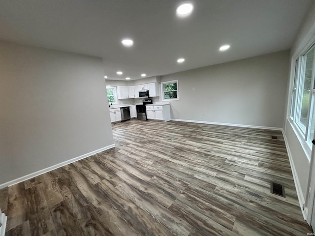 205 Corwin Ln, Fort Wayne, IN 46816 - unfurnished living room with recessed lighting and dark wood finished floors