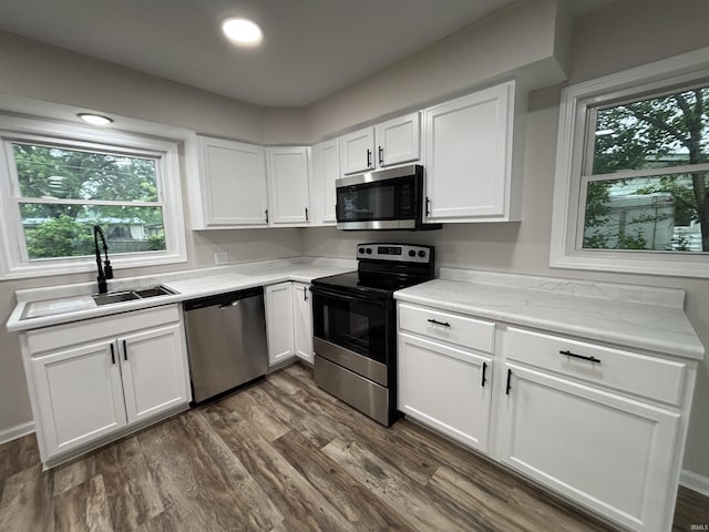 205 Corwin Ln, Fort Wayne, IN 46816 - kitchen with stainless steel appliances, light countertops, white cabinetry, and dark wood-style floors